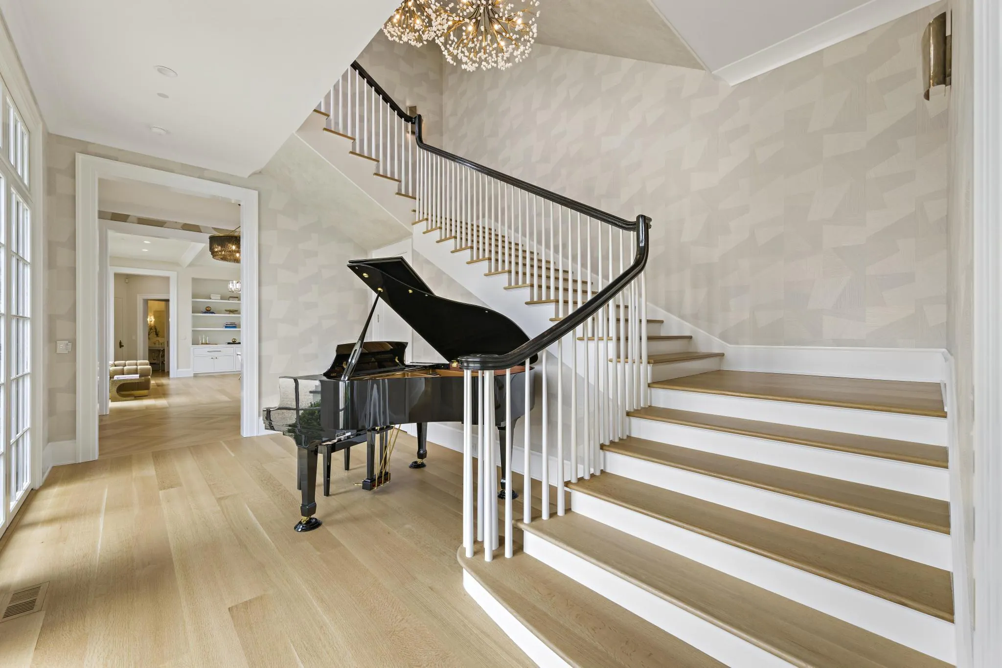 Staircase piano at American Dream, a Merrick Construction custom home in Rumson, New Jersey